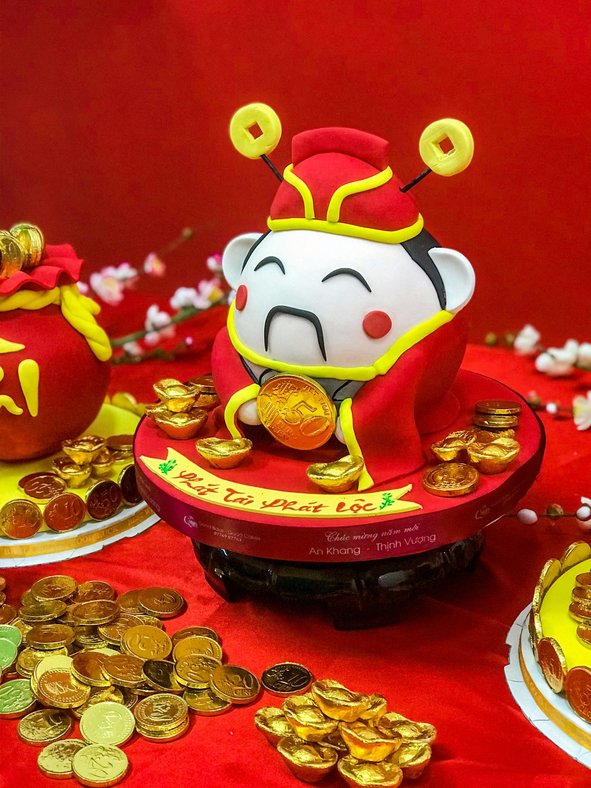A charming Chinese figurine surrounded by gold coins symbolizing prosperity and luck.