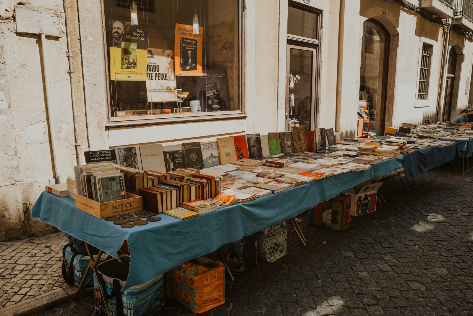 Books are displayed on a table outside a shop.