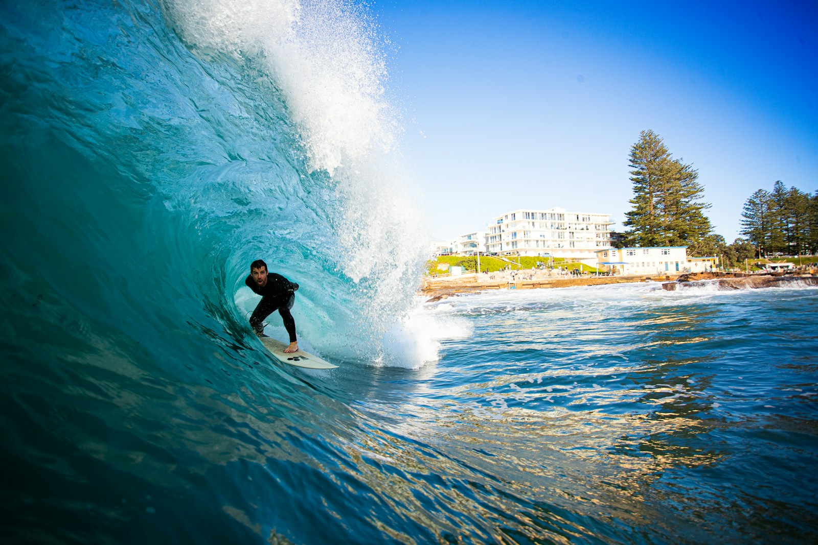 Surfer rides inside a massive ocean wave tube.